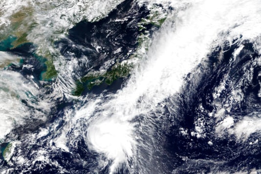 This Monday, Sept. 21, 2020, satellite image released by NASA Worldview, Earth Observing System Data and Information System (EOSDIS) shows Tropical Storm Dolphin moving northbound toward Japan. The tropical storm developing in the Pacific Ocean, was slowly sweeping toward Japan Tuesday, threatening the main island of Honshu with heavy rainfall and harsh winds. (NASA via AP)