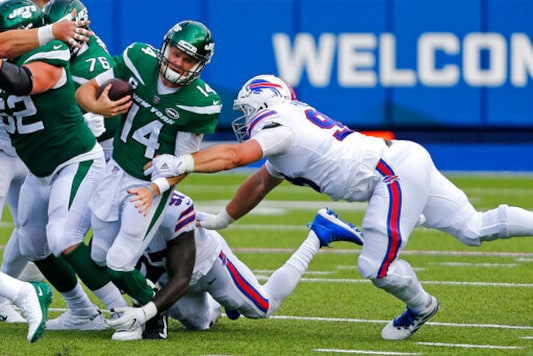 New York Jets quarterback Sam Darnold (14) is sacked by Buffalo Bills defensive end Mario Addison (97), center rear, and Harrison Phillips, right, during the second half of an NFL football game in Orchard Park, N.Y., Sunday, Sept. 13, 2020. (AP Photo/Jeffrey T. Barnes) New York Jets quarterback Sam Darnold (14) is sacked by Buffalo Bills defensive end Mario Addison (97), center rear, and Harrison Phillips, right, during the second half of an NFL football game in Orchard Park, N.Y., Sunday, Sept. 13, 2020. (AP Photo/Jeffrey T. Barnes)