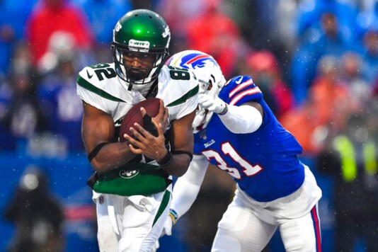 File-New York Jets wide receiver Jamison Crowder (82) catches a pass for a touchdown in front of Buffalo Bills' Dean Marlowe (31) during the second half of an NFL football game Sunday, Dec. 29, 2019, in Orchard Park, N.Y.  New York Jets wide receivers Breshad Perriman and Crowder sat out practice Wednesday, Sept. 23, 2020, with injuries, and they could miss the team's game at Indianapolis on Sunday. (AP Photo/Adrian Kraus, File)