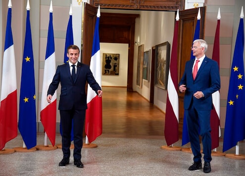 Latvian Prime Minister Krisjanis Karins, right, and French President Emmanuel Macron pose for a photo prior to their meeting at the National Museum of Arts in Riga, Latvia, Wednesday, Sept. 30, 2020. (AP Photo/Roman Koksarov)