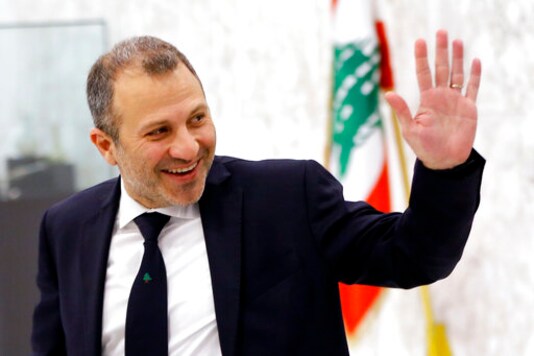 FILE - This Feb. 2, 2019 file photo, then Lebanese Foreign Minister Gebran Bassil arrives to attend a meeting of the Lebanese cabinet at the Presidential Palace in Baabda, east of Beirut, Lebanon. A former Lebanese foreign minister and son-in-law of President Michel Aoun has tested positive for the new coronavirus, his office said Sunday, Sept. 27, 2020. (AP Photo/Bilal Hussein, File)