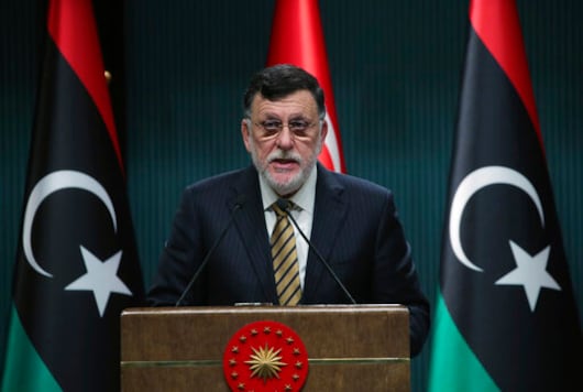 FILE - In this June 4, 2020 file photo, Fayez Sarraj, the head of Libya's internationally-recognized government, speaks at a joint news conference with Turkey's President Recep Tayyip Erdogan, in Ankara, Turkey.   Libyas U.N.-supported government Friday, Aug. 21, 2020, announced a cease-fire across the oil-rich country and called for demilitarizing the strategic city of Sirte, which is controlled by rival forces.  (Turkish Presidency via AP, Pool)