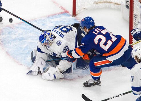Tampa Bay Lightning goalie Andrei Vasilevskiy (88) makes a save against New York Islanders' Anders Lee (27) during third-period NHL Eastern Conference final playoff game action in Edmonton, Alberta, Sunday, Sept. 13, 2020. (Jason Franson/The Canadian Press via AP)