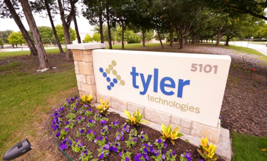 The sign for Tyler Technologies is seen outside the company's offices, Thursday, Sept. 24, 2020, in Plano, Texas. The major U.S. provider of software services to state and local governments, including the online publishing of election results, has told customers that an unknown intruder broke into its phone and IT systems. Plano, Texas-based Tyler Technologies told customers in an email that it discovered the breach and contacted law enforcement and enlisted outside cybersecurity help. (AP Photo/LM Otero)