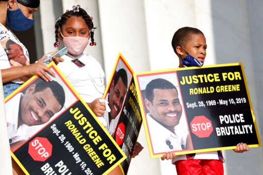 FILE - In this Aug. 28, 2020 file photo, family members of Ronald Greene listen to speakers as demonstrators gather for the March on Washington, in Washington, on the 57th anniversary of the Rev. Martin Luther King Jr.'s 