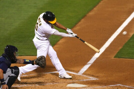 Oakland Athletics' Marcus Semien hits a double against Seattle Mariners during the third inning of a baseball game in Oakland, Calif., Friday, Sept. 25, 2020. (AP Photo/Jed Jacobsohn)