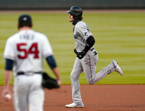 Miami Marlins' Brian Anderson, right, rounds the bases in front of Atlanta Braves starting pitcher Max Fried, left, after hitting a solo home run in the first inning of a baseball game Wednesday, Sept. 23, 2020, in Atlanta. (AP Photo/John Bazemore)