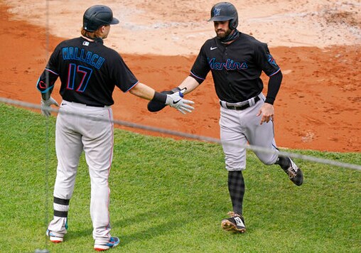 Miami Marlins Chad Wallach (17) greets Marlins Jon Berti after Berti scored on Jazz Chisholm's two-run double during the second inning of a baseball game against the New York Yankees, Sunday, Sept. 27, 2020, at Yankee Stadium in New York. (AP Photo/Kathy Willens)