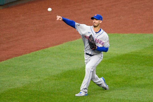 New York Mets starting pitcher Rick Porcello tosses the ball before a baseball game against the Washington Nationals, Friday, Sept. 25, 2020, in Washington. The game was postponed due to inclement weather. (AP Photo/Nick Wass)