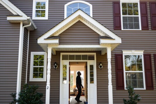 FILE - In this July 21, 2020, file photo, a homeowner tours his new home, in Washingtonville, N.Y. U.S. average rates on long-term mortgages fell this week amid signs that the halting economic recovery slowed over the summer. The key 30-year mortgage again marked an all-time low. Mortgage buyer Freddie Mac reports that the average rate on the 30-year home loan declined to 2.86% from 2.93% last week. (AP Photo/John Minchillo, File) FILE - In this July 21, 2020, file photo, a homeowner tours his new home, in Washingtonville, N.Y. U.S. average rates on long-term mortgages fell this week amid signs that the halting economic recovery slowed over the summer. The key 30-year mortgage again marked an all-time low. Mortgage buyer Freddie Mac reports that the average rate on the 30-year home loan declined to 2.86% from 2.93% last week. (AP Photo/John Minchillo, File)
