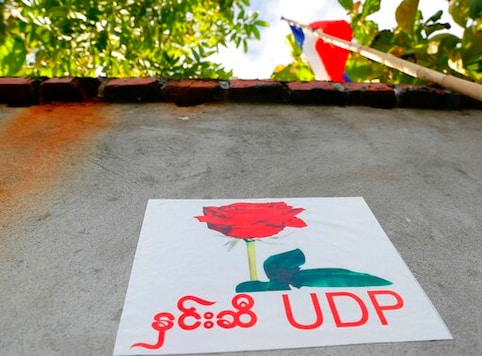 A poster of the United Democratic Party is posted on the wall of the party's headquarters Wednesday, Sept. 30, 2020, in Naypyitaw, Myanmar. Kyaw Myint, the chairman of the United Democratic Party has been arrested as a fugitive from justice after recent reports in Myanmar media contained allegations of a shady past, including financial finagling and a prison escape. The party is fielding the second highest number of candidates for the November elections, and other party executives say it will carry on campaigning. (AP Photo / Aung Shine Oo)