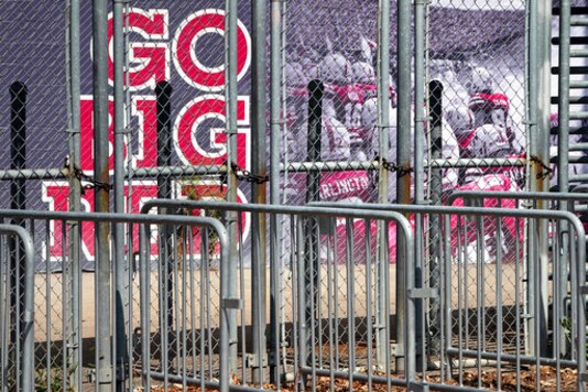 A mural showing Nebraska football players and Go Big Red lettering are seen past locked gates at Memorial Stadium in Lincoln, Neb., Tuesday, Sept. 15, 2020. (AP Photo/Nati Harnik)