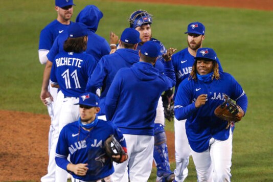 Toronto Blue Jays celebrate a 5-2 win over the Baltimore Orioles in a baseball game Saturday, Sept. 26, 2020, in Buffalo, N.Y. (AP Photo/Jeffrey T. Barnes)