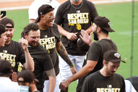 San Diego Padres' Manny Machado, left, and Eric Hosmer, right, celebrate after the Padres beat the Seattle Mariners in a baseball game Sunday, Sept. 20, 2020, in San Diego. The Padres clinched a spot in the playoffs. (AP Photo/Denis Poroy) San Diego Padres' Manny Machado, left, and Eric Hosmer, right, celebrate after the Padres beat the Seattle Mariners in a baseball game Sunday, Sept. 20, 2020, in San Diego. The Padres clinched a spot in the playoffs. (AP Photo/Denis Poroy)