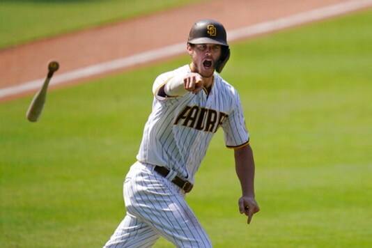 FILE - In this Aug. 27, 2020 file photo, the San Diego Padres' Wil Myers reacts after hitting a three-run walkoff home run to defeat the Seattle Mariners in a baseball game in San Diego. Wil Myers is back. While Manny Machado and Fernando Tatis Jr. have grabbed most of the attention on the playoff-bound Padres, Myers' comeback performance has also been instrumental in returning San Diego to postseason play for the first time since 2006. Myers is hitting .291 with 14 homers and 38 RBIs in 52 games. (AP Photo/Gregory Bull, File)