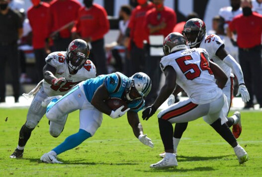 Carolina Panthers running back Mike Davis (28) splits between Tampa Bay Buccaneers linebacker Devin White (45) and outside linebacker Lavonte David (54) during the second half of an NFL football game Sunday, Sept. 20, 2020, in Tampa, Fla. (AP Photo/Jason Behnken)