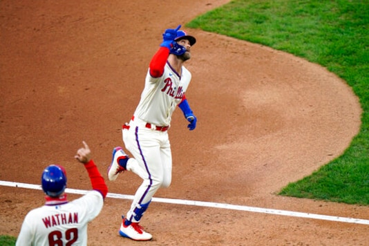 Philadelphia Phillies' Bryce Harper, right, reacts with third base coach Dusty Wathan after hitting a two-run home run off Toronto Blue Jays pitcher Robbie Ray during the fifth inning of the first baseball game in a doubleheader, Friday, Sept. 18, 2020, in Philadelphia. (AP Photo/Matt Slocum) Philadelphia Phillies' Bryce Harper, right, reacts with third base coach Dusty Wathan after hitting a two-run home run off Toronto Blue Jays pitcher Robbie Ray during the fifth inning of the first baseball game in a doubleheader, Friday, Sept. 18, 2020, in Philadelphia. (AP Photo/Matt Slocum)