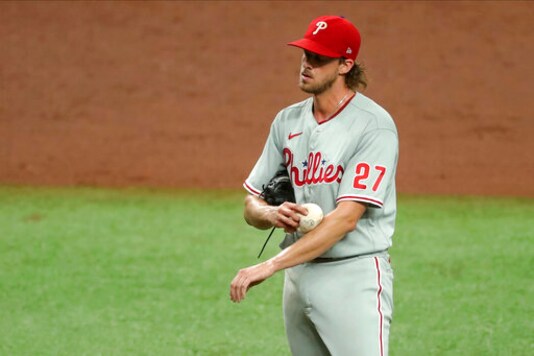 Philadelphia Phillies starting pitcher Aaron Nola reacts after giving up a single to Tampa Bay Rays' Hunter Renfroe to score the third Rays run during the third inning of a baseball game Sunday, Sept. 27, 2020, in St. Petersburg, Fla. (AP Photo/Mike Carlson)