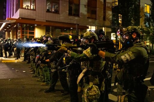 FILE - In this Friday, Sept. 18, 2020, file photo, Federal police try to take control of the streets during protests in Portland, Ore. The protests, which began over the killing of George Floyd, often result frequent clashes between protesters and law enforcement. Vandalism but no arrests occurred during a demonstration in downtown Portland involving about 200 people Saturday, Sept. 19, 2020. Frequently violent protests have racked the city for more than three months since the police killing of George Floyd in Minneapolis. Protesters want city officials to slash the police budget and reallocate money to Black residents and businesses. Some demonstrators also demand the resignation of the city's mayor. (AP Photo/Paula Bronstein, File)
