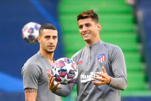 Atletico Madrid's Alvaro Morata holds a ball during a training session at the Jose Alvalade stadium in Lisbon, Wednesday Aug. 12, 2020. Atletico Madrid will play Leipzig in a Champions League quarterfinals soccer match on Thursday. (Lluis Gene/Pool via AP)