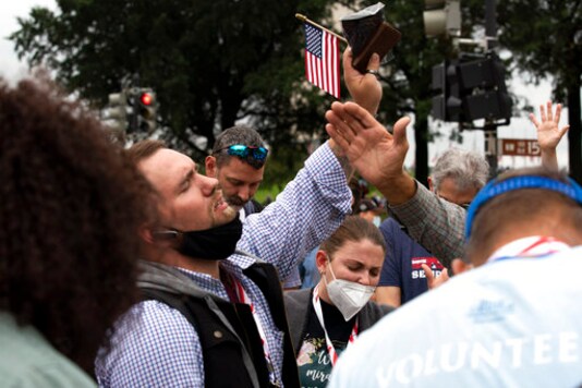 Followers of Franklin Graham pray as they march from the Lincoln Memorial to Capitol Hill, during the Prayer March at the National Mall, in Washington, Saturday, Sept. 26, 2020. (AP Photo/Jose Luis Magana)