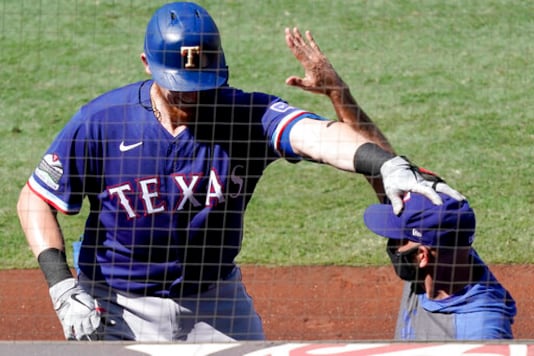 Texas Rangers' Sam Huff, left, reaches out to manager Chris Woodward who gives him congratulations after Huff hit a solo home run against the Los Angeles Angels during the fourth inning of a baseball game in Anaheim, Calif., Sunday, Sept. 20, 2020. (AP Photo/Alex Gallardo) Texas Rangers' Sam Huff, left, reaches out to manager Chris Woodward who gives him congratulations after Huff hit a solo home run against the Los Angeles Angels during the fourth inning of a baseball game in Anaheim, Calif., Sunday, Sept. 20, 2020. (AP Photo/Alex Gallardo)