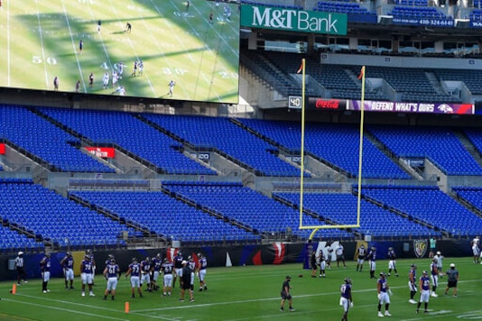 Baltimore Ravens warm up during an NFL football training camp practice in an empty stadium, Saturday, Aug. 29, 2020, in Baltimore, Md.(AP Photo/Gail Burton) Baltimore Ravens warm up during an NFL football training camp practice in an empty stadium, Saturday, Aug. 29, 2020, in Baltimore, Md.(AP Photo/Gail Burton)
