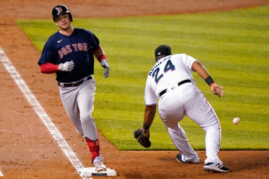 Boston Red Sox's Bobby Dalbec beats the throw to Miami Marlins first baseman Jesus Aguilar (24) for a singe during the fifth inning of a baseball game, Tuesday, Sept. 15, 2020, in Miami. (AP Photo/Lynne Sladky)