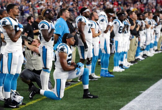 FILE - In this Aug. 22, 2019, file photo, Carolina Panthers strong safety Eric Reid (25) kneels during the national anthem before the team's NFL preseason football game against the New England Patriots in Foxborough, Mass. Despite setting two defensive franchise records for the Panthers last season, Reid remains unsigned like his close friend Colin Kaepernick. Washington coach Ron Rivera, Reids former coach in Carolina, gave him a strong endorsement Wednesday, Sept. 16. I would tell them hes a heckuva teammate, Rivera said. 