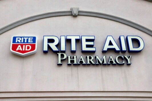This is the sign on a Rite Aid Pharmacy in Pittsburgh, Pa., Tuesday, April 14, 2020.  Rite Aid topped Wall Street expectations for the fiscal second quarter, Thursday, Sept. 24,  and gave a revised annual forecast, one quarter after withdrawing it due to COVID-19 uncertainty. (AP Photo/Gene J. Puskar)