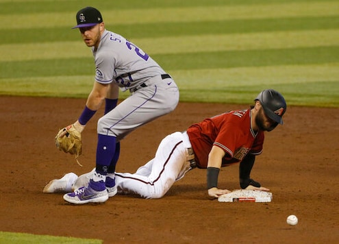 Colorado Rockies shortstop Trevor Story, left, looks for the ball after Arizona Diamondbacks' Wyatt Mathisen dove back into second base during the fourth inning of a baseball game Sunday, Sept. 27, 2020, in Phoenix. (AP Photo/Darryl Webb) Colorado Rockies shortstop Trevor Story, left, looks for the ball after Arizona Diamondbacks' Wyatt Mathisen dove back into second base during the fourth inning of a baseball game Sunday, Sept. 27, 2020, in Phoenix. (AP Photo/Darryl Webb)
