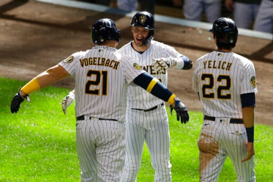 Milwaukee Brewers' Daniel Vogelbach, left, is congratulated by Ryan Braun, center, and Christian Yelich, right, after hitting a three-run home run during the sixth inning of a baseball game against the Kansas City Royals Sunday, Sept. 20, 2020, in Milwaukee. (AP Photo/Aaron Gash) Milwaukee Brewers' Daniel Vogelbach, left, is congratulated by Ryan Braun, center, and Christian Yelich, right, after hitting a three-run home run during the sixth inning of a baseball game against the Kansas City Royals Sunday, Sept. 20, 2020, in Milwaukee. (AP Photo/Aaron Gash)