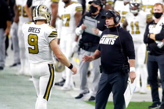 New Orleans Saints head coach Sean Payton speaks with quarterback Drew Brees (9) during the first half of an NFL football game against the Las Vegas Raiders, Monday, Sept. 21, 2020, in Las Vegas. (AP Photo/Isaac Brekken)