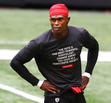 Atlanta Falcons wide receiver Julio Jones wears a shirt in honor of John Lewis while preparing to play the Seattle Seahawks in am NFL football game on Sunday, Sept. 13, 2020, in Atlanta. (Curtis Compton/Atlanta Journal-Constitution via AP)