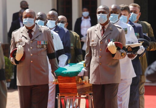 Pallbearers carry the coffin during the official funeral of George Bizos at the Hellenic Cultural Centre in Johannesburg, South Africa, Thursday, Sept. 17 2020.  Bizos, a human rights activist and lawyer who represented Nelson Mandela during the Rivonia Trial, passed away last week at the age of 92. (AP Photo/Kim Ludbrook)