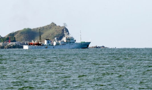 South Korea's government ship for a fishery guidance is seen near Yeonpyeong island, South Korea, Saturday, Sept. 26, 2020. South Korea said Saturday it will request North Korea to further investigate the killing of a South Korean government official who was shot by North Korean troops after being found adrift near the rivals' disputed sea boundary while apparently trying to defect. (Choi Jin-suk/Newsis via AP)