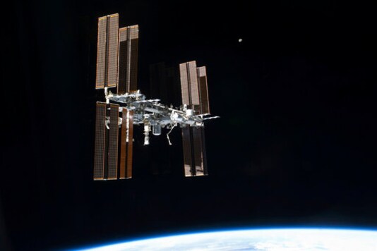 FILE - This July 19, 2011 photo of the International Space Station was taken from the space shuttleAtlantis. On Tuesday, Sept. 29, 2020, NASA said that the two Russians and one American on board were awakened late Monday to hurriedly seal hatches between compartments and search for the ongoing leak, which appeared to be getting worse. It was the third time in just over a month that the crew had to isolate themselves on the Russian side, in an attempt to find the growing leak.  (NASA via AP)