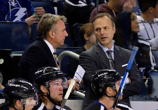 FILE - In this Nov. 21, 2015, file photo, Tampa Bay Lightning head coach Jon Cooper, right, talks to assistant coach Rick Bowness during the first period of an NHL hockey game against the Anaheim Ducks in Tampa, Fla. For the first time in NHL history, a coach is facing a former assistant in the Stanley Cup Final. Dallas Stars interim coach Bowness worked five years as an assistant under Cooper with the Lightning. They parted ways in 2008 and are now facing off in a series of old school vs. new school coaches. (AP Photo/Chris O'Meara, File)