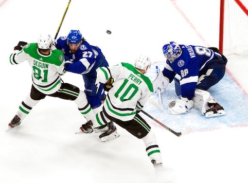 Dallas Stars' Tyler Seguin (91) and Corey Perry (10) battle Tampa Bay Lightning's Ryan McDonagh (27) as Lightning goalie Andrei Vasilevskiy (88) makes a save during third-period NHL Stanley Cup finals hockey action in Edmonton, Alberta, Monday, Sept. 21, 2020. (Jason Franson/The Canadian Press via AP) Dallas Stars' Tyler Seguin (91) and Corey Perry (10) battle Tampa Bay Lightning's Ryan McDonagh (27) as Lightning goalie Andrei Vasilevskiy (88) makes a save during third-period NHL Stanley Cup finals hockey action in Edmonton, Alberta, Monday, Sept. 21, 2020. (Jason Franson/The Canadian Press via AP)