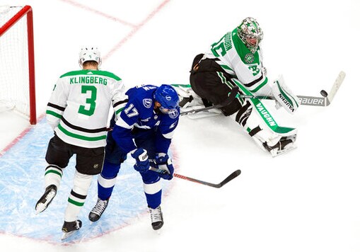 Dallas Stars goaltender Anton Khudobin (35) makes a save as Tampa Bay Lightning's Alex Killorn (17) and Stars' John Klingberg (3) battle in the crease during third-period NHL Stanley Cup finals hockey action in Edmonton, Alberta, Saturday, Sept. 19, 2020. (Jason Franson/The Canadian Press via AP)