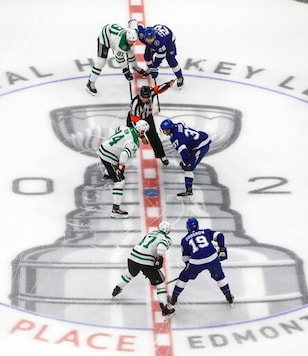 Players from the Dallas Stars and the Tampa Bay Lightning line up for the face off during first-period NHL Stanley Cup finals hockey action in Edmonton, Alberta, Saturday, Sept. 19, 2020. (Jason Franson/The Canadian Press via AP) Players from the Dallas Stars and the Tampa Bay Lightning line up for the face off during first-period NHL Stanley Cup finals hockey action in Edmonton, Alberta, Saturday, Sept. 19, 2020. (Jason Franson/The Canadian Press via AP)