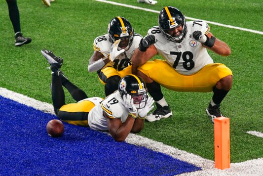 Pittsburgh Steelers wide receiver JuJu Smith-Schuster (19) offensive tackle Alejandro Villanueva (78) and wide receiver Diontae Johnson (18) celebrate after Smith-Schuster scored a touchdown against the New York Giants during the fourth quarter of an NFL football game Monday, Sept. 14, 2020, in East Rutherford, N.J. (AP Photo/Seth Wenig)