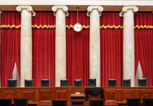 This Sept. 19, 2020, photo provided by the Supreme Court, shows the Bench draped for the death of Supreme Court Associate Justice Ruth Bader Ginsburg at the Supreme Court in Washington. (Fred Schilling/Collection of the Supreme Court of the United States via AP)