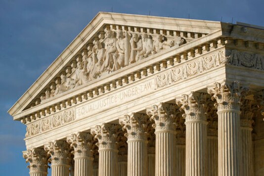 FILE - In this May 3, 2020 photo, the setting sun shines on the Supreme Court building on Capitol Hill in Washington. (AP Photo/Patrick Semansky, File)