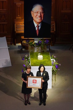Taiwan President Tsai Ing-wen, right, attends a memorial service for former President Lee Teng-hui with his daughter in Taipei, Taiwan on Saturday, Sept. 19, 2020. Lee led the island's transition to democracy and died at age 97 in July. (Pool Photo via AP Photo)
