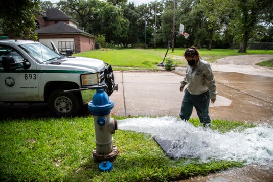 Kristina Watson, a Lake Jackson water waste operator flushes water out from a fire hydrant on Monday, Sept. 28, 2020, in Lake Jackson, Texas. Texas Gov. Greg Abbott issued a disaster declaration on Sunday after a brain-eating amoeba was discovered in the water supply for Lake Jackson, Texas. The disaster declaration extends across Brazoria County, where Lake Jackson is located.The disaster declaration comes after the death of a 6-year-old boy who was infected by a brain-eating amoeba. (Marie D. De Jess/Houston Chronicle via AP)