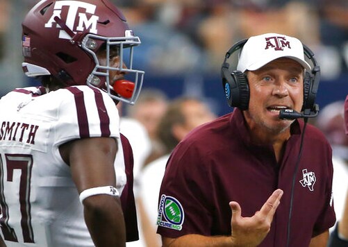 FILE - In this Sept. 28, 2019, file photo, Texas A&M head coach Jimbo Fisher talks with his team as wide receiver Ainias Smith (17) looks on as they play Arkansas during the first half of an NCAA college football game in Arlington, Texas. Texas A&M's football program was placed on probation and Fisher given a six-month show cause order by the NCAA on Thursday, July 2, 2020, after the Aggies were found to have violated recruiting and other rules beginning in January 2018. (AP Photo/Ron Jenkins, File) FILE - In this Sept. 28, 2019, file photo, Texas A&M head coach Jimbo Fisher talks with his team as wide receiver Ainias Smith (17) looks on as they play Arkansas during the first half of an NCAA college football game in Arlington, Texas. Texas A&M's football program was placed on probation and Fisher given a six-month show cause order by the NCAA on Thursday, July 2, 2020, after the Aggies were found to have violated recruiting and other rules beginning in January 2018. (AP Photo/Ron Jenkins, File)
