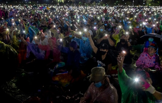 Pro-democracy protesters hold up mobile phone lights to live music during a rally at Sanam Luang in Bangkok, Thailand, Saturday, Sept. 19, 2020. Protesters gathered Saturday in Bangkok for the most ambitious rally so far in a pro-democracy campaign that has shaken up the government and the country's conservative establishment. (AP Photo/Gemunu Amarasinghe) Pro-democracy protesters hold up mobile phone lights to live music during a rally at Sanam Luang in Bangkok, Thailand, Saturday, Sept. 19, 2020. Protesters gathered Saturday in Bangkok for the most ambitious rally so far in a pro-democracy campaign that has shaken up the government and the country's conservative establishment. (AP Photo/Gemunu Amarasinghe)