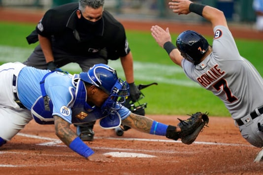 Detroit Tigers Austin Romine (7) misses the plate while sliding against Kansas City Royals catcher Salvador Perez, left, during the first inning of a baseball game at Kauffman Stadium in Kansas City, Mo., Saturday, Sept. 26, 2020. Romine was then tagged out by Perez. (AP Photo/Orlin Wagner) Detroit Tigers Austin Romine (7) misses the plate while sliding against Kansas City Royals catcher Salvador Perez, left, during the first inning of a baseball game at Kauffman Stadium in Kansas City, Mo., Saturday, Sept. 26, 2020. Romine was then tagged out by Perez. (AP Photo/Orlin Wagner)