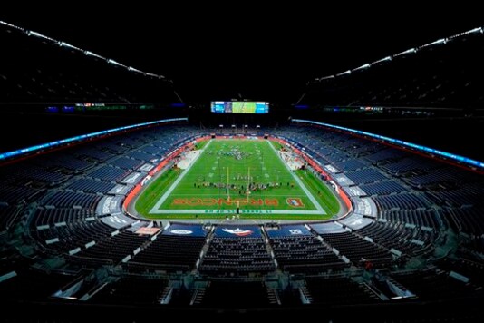The Denver Broncos and the Tennessee Titans take the field in an empty stadium prior to an NFL football game, Monday, Sept. 14, 2020, in Denver. (AP Photo/Jack Dempsey)